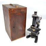 An oak cased Beck model 47 monocular microscope with x10 eye piece, height 31.5cm.