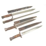 Three late 19th/early 20th century British military issue wooden handled bayonets,