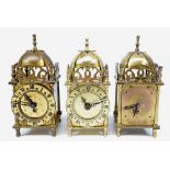 Three Smiths 20th century small brass lantern clocks, two with battery movement,