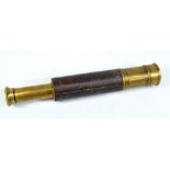 FRED MANBY & BRO OF SKIPTON; a brass two-draw telescope with part leather and part brass barrel,