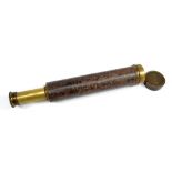 A 1.5" brass three-draw telescope indistinctly signed and with leather barrel, length 26cm.