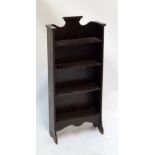 An early 20th century oak open bookcase of slim proportions, width 55cm.