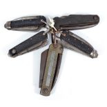 Five army issue clasp knives with checkered faces and ring loop attachments,