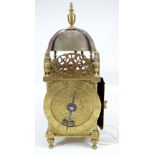 A 20th century brass lantern clock with Roman numerals to the chapter ring and domed bell beneath