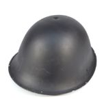 A mid-20th century black painted helmet with internal leather liner and expanding canvas chin strap,