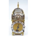 A 20th century brass lantern clock with silvered chapter ring set with Roman numerals,