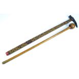 An engraved war pick with stud decorated shaft, length 82cm, and a wooden knobkerrie, length 80cm,