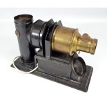A black painted tin and brass mounted magic lantern, length 36cm.