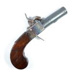 A small percussion cap muff pistol with screw-off barrel, engraved lock and walnut stock,
