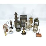A collection of various storm lamps, oil lamp sections, etc.