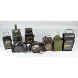 Eight various vintage lamps including an electric signalling daylight lamp by Lucas,
