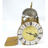 A 20th century brass lantern clock with silver dial set with Roman numerals,