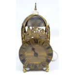 A 20th century brass lantern clock with Roman numerals to the chapter ring and domed bell,