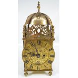 A 20th century brass lantern clock with Roman numerals to the chapter ring,