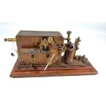 A late 19th century brass bodied telegraph sounder on wooden base,