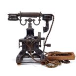An early 20th century 'Eiffel Tower' skeleton telephone on shaped cast iron base above twin bells,