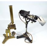 An unnamed brass monocular microscope with hinged tripod base, height 39cm,