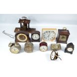 A quantity of time pieces, alarm clocks and clock parts, including two movements,