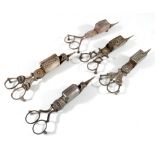 A pair of patent wick trimmers by Cope & Cutler and four further pairs of wick trimmers,
