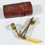 A Georgian brass and ivory handled travelling field microscope, with card case, length 8cm.