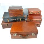 A group of eight vintage leather suitcases of various sizes, one with gilt tooled initials 'R.R.R.