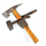 A mid-20th century wooden handled hatchet, the head with rubbed stamp and leather blade protectors,