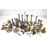 A mixed lot of candlesticks, chambersticks, jugs and tankards, predominantly in pewter and brass.
