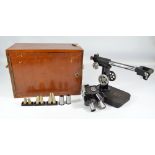 BAKER OF LONDON; a walnut cased mid-20th century binocular microscope,