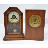 A late 19th century American walnut mantel clock with Roman numerals to the circular dial,