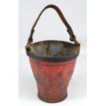 An early 19th century leather fireman's bucket with twin iron ring loops,