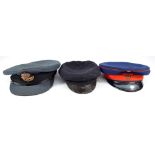 Three peaked cloth caps to include blue example with bullion work and gilt eagle Air Ministry badge
