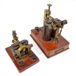 Two telegraph sounders on wooden bases, the larger with frontal plaque inscribed 'F.G.