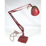 An original mid-20th century red painted adjustable table lamp with weighted rounded square