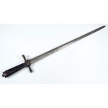 A 19th century European short sword, with tapering checkered wooden grip,