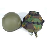 Two green painted late 20th century helmets, one with outer camouflage pattern cover,