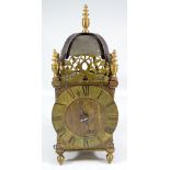 A 20th century brass lantern clock with Roman numerals to chapter ring,