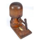 An early 20th century beech hat block with large winding thread and size plaque to the base,