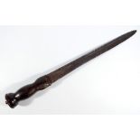 A 19th century dirk with wooden grip, simple pommel and tapering blade, overall length 47cm.