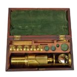 A mahogany cased Cuff type travelling brass microscope with various lenses, height 24cm.