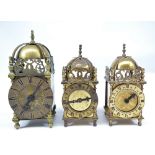 Three 20th century brass lantern clocks, one with movement inscribed 'Devall de Luxe', height 21cm,