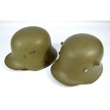 Two German WWII green painted helmets, one with internal leather lining (replacement),