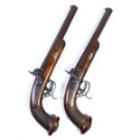 A fine pair of percussion cap pistols with foliate engraved decoration to the lock,