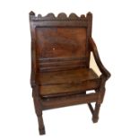 An 18th century and later oak Wainscot chair with swept arms and turned front legs (lacking seat).