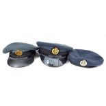 Two military blue cloth caps and one beret, all with RAF badges (two metal, one cloth),