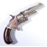 A five shot rimfire revolver, the top of barrel stamped 'XXX Standard 1872',