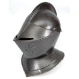 A reproduction medieval style knight's helmet with hinged and pierced face guard, height 34cm.
