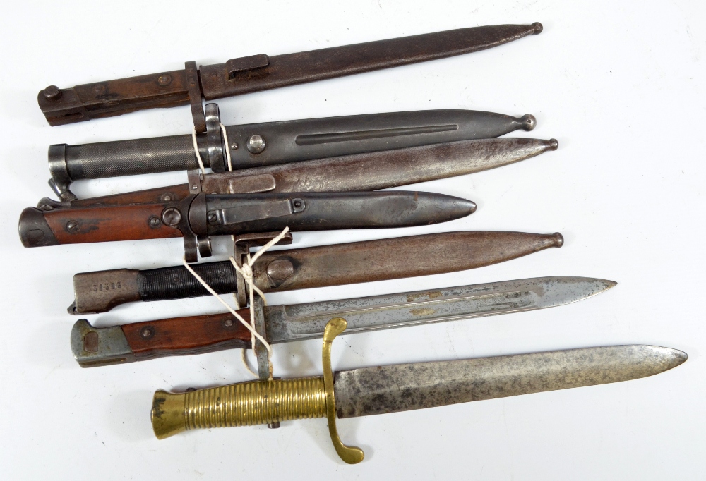 Seven various bayonets, five in scabbards, one with brass grip and with various markings (7).