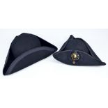 Two black tricorn hats,