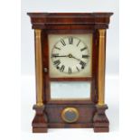 A late 19th century American rosewood mantel clock with associated dial set with Roman numerals and