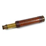 DOLLAND OF LONDON; a 1.25" brass three-draw telescope with leather barrel, length 24cm.